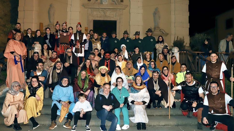 I figuranti della Via Crucis dello scorso aprile intorno ad Amana Volpi, davanti agli alpini al centro della foto