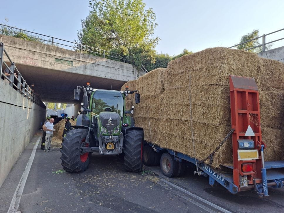 Trattore sterza e rovescia le balle di fieno su due auto e due moto a Romano -Foto